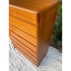 a wooden chest sitting on top of a white sheet