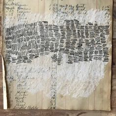 an old piece of paper with writing on it sitting on top of a wooden table