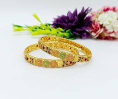 ❖ ❖ ❖ Features: ❖ An Indian styled Meenakari Bangles. ❖ Made from fine Quality Brass with Gold Platting. ❖ Ready to be given as a gift. ❖ Easy and Convenient way to Wear. ❖ It looks prettier than the images. Direct Images on hand is also attached. Size of Bangle & Other Details: ❖ Size:- You Choose ❖ Quantity:- One Pair ❖ Material:- Fine Quality Brass with Gold Platting  This gold plated unique bracelet is glamorously impressive, yet subtle, the design is clean and extremely accurate and suited to any kind of event, both formal and informal, featuring an amazing meenakari, this is one of my favorite items!  It looks beautiful, is durable & also affordable. These bangles is designed for all age groups from office going girl to a housewife. Featuring an exquisite design, these bangles will g Indian Jewelry Traditional, Meenakari Bangles, Jaipur Jewelry, Gold Bangles Indian, Jewelry Traditional, Stone Necklace Set, Traditional Indian Jewellery, Wedding Bracelets, The Bangles