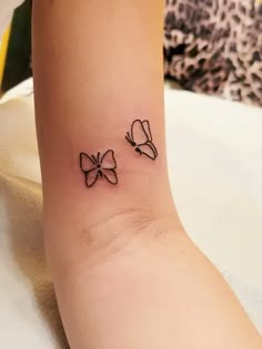 two small bows on the ankle are shown in black ink, and one has a bow tattoo