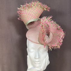 Add a pop of fun and color to your outfit with this one-of-a-kind curly pale pink and sage green fascinator. The unique coiling design rises upwards making this headpiece a true statement piece. Handcrafted with care and attention to detail, this fascinator features high-quality materials and expert craftsmanship. The soft and lightweight feel ensures all-day comfort, while the secure headband attachment ensures it stays in place. Perfect for weddings, garden parties, or any special occasion whe Whimsical Pink Summer Hat, Fun Green Mini Hats For Parties, Fun Green Mini Hats For Party, Fun Pink Mini Hats For Party, Green Fun Party Mini Hats, Whimsical Green Headpiece For Parties, Elegant Multicolor Headpiece For Spring, Pink Whimsical Fascinator For Garden Party, Whimsical Pink Fascinator For Garden Party