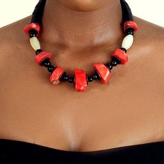 This necklace is handmade with large real coral beads. Once reserved for the nobility of great kingdoms such as the Benin Empire, coral beads are a symbol of royalty and wealth. These earth tone vintage beads add a regal touch to any look. Red Coral Beaded Necklaces With Wooden Beads, Red Coral Necklace With Wooden Beads, Artisan Red Coral Necklace With Large Beads, Red Coral Necklace With Large Beads, Red Coral Jewelry With Wooden Beads, Traditional Red Coral Beaded Necklace, Traditional Beaded Necklace With Red Coral And Natural Stones, Red Coral Beaded Necklaces, Artisan Red Coral Beaded Necklaces With Gemstone Beads