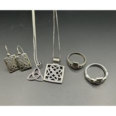 This Sterling Silver Jewelry Set Features Two Celtic Style Necklaces, A Pair Of Earrings, And Two Claddaugh Rings, Totaling 17g In Weight. The Ring Pieces Is Made By Solvar, Both Rings Are Made In Ireland, Are Crafted From 925 Sterling Silver. Necklaces Are The Double Triquetra Aka Celtic Triangle, Trinity Knot And Traditional Irish Necklace. Sterling Silver 925 Earrings. 2 Irish Claddagh Rings, One Is Made By Solvar. Sterling Silver Wt 17 Grams Tarnishing Noted In Small Areas. The Necklaces Are Designed With A Chain And Pendant Style, While The Earrings And Rings Feature Intricate Irish Themes. The Silver Color And High-Quality Metal Purity Make These Pieces Perfect For Any Occasion. Add Irish Claddagh Rings, Claddaugh Ring, Celtic Triangle, Irish Necklace, Irish Ring Claddagh, 925 Earrings, Silver Jewelry Set, Irish Claddagh, Chain And Pendant