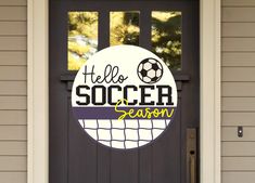 a door with a sign that says hello soccer season on it and a ball in the net