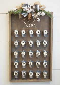 a wooden calendar with bells and numbers on it