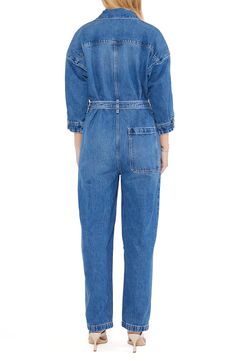 With a classic blue wash, this belted jumpsuit with a zip-front closure and plethora of pockets is a stylish way to make an all-denim statement. Point collar Three-quarter sleeves 77% cotton, 23% Tencel® Refibra™ lyocell Tencel Refibra lyocell is a sustainably produced fiber made from wood pulp and recycled cotton scraps using closed-loop processing Machine wash, line dry Imported Denim Belted Overalls Jumpsuits And Rompers, Casual Denim Belted Jumpsuits And Rompers, Denim Jumpsuit With Belt Loops For Workwear In Spring, Chic Denim Belted Jumpsuits And Rompers, Spring Denim Jumpsuit For Work With Belt Loops, Casual Denim Belted Jumpsuit, Spring Denim Jumpsuit With Belt Loops For Work, Casual Denim Jumpsuit With Belt Loops For Work, Spring Denim Belted Jumpsuits And Rompers