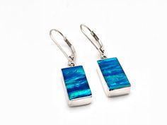 Hi everyone, just wanted to let you know we are open and shipping daily. Rectangular Blue Opal Earrings Set in 925 Sterling Silver // Lever Earwires // Blue Fire Opal Earrings Length: 1.25 inches Stone: Lab Created Fire Opal Origin: Japan Hallmark 925 Finished on the back side. Return Policy: If you are not 100% satisfied, I will exchange or refund your purchase. Returns or exchanges must be made within 14 days of purchase date of merchandise. Please include everything in the box we sent to you. Blue Polished Drop Earrings, Blue Drop Earrings With Polished Finish, Blue Sterling Silver Earrings With Polished Finish, Sterling Silver Oblong Earrings For Gift, Blue Sterling Silver Earrings With French Hook, Sterling Silver Blue French Hook Earrings, Rectangular Polished Earrings For Gift, Rectangular Polished Earrings For Gifts, Rectangular Polished Finish Earrings For Gift