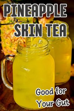 A close-up of two mason jars filled with pineapple skin tea and ice, garnished with a slice of pineapple skin. Tea Mixes, Pineapple Core, Pineapple Tea