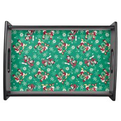 a green tray with mickey mouse and snowflakes on the bottom, in front of a white background