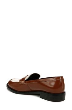 Minimalist design showcases the timeless silhouette of this sleek patent penny loafer with ergonomic padding at key pressure points for all-day comfort. 1" heel Synthetic upper, lining and sole Imported Classic Brown Flat Loafers, Modern Brown Loafers For Business Casual, Modern Brown Loafers For Office, Brown Patent Leather Slip-on Loafers, Brown Patent Leather Loafers With Round Toe, Classic Patent Leather Loafers For Office, Modern Brown Loafers With Almond Toe, Modern Brown Almond Toe Loafers, Classic Patent Leather Loafers For Business Casual