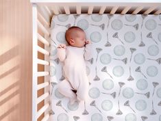 a baby is sleeping in a crib