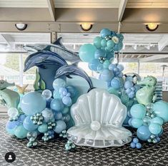 a large balloon sculpture with dolphins, dolphins and seashells