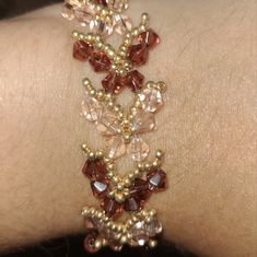 a close up of a person's wrist with beads on it