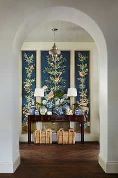 an archway leading into a living room with blue and white wallpaper