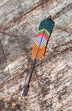 Elevate your style with a stunning hand-beaded feather hat pin. This 3.5" long wearable art piece is a unique and stylish accessory that adds a touch of handmade  western flair  to any outfit or hat. Beaded Feathers, Beaded Feather, Beaded Hat, Feather Hat, Hat Pin, Stick Pins, Hat Pins, Stylish Accessories, Wearable Art