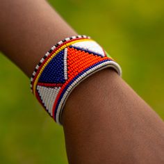 This handmade African bracelet is the ultimate statement piece. Made with traditional Maasai beads, these bright and beautiful pieces will add the perfect finishing touch to any outfit. In East Africa, every beaded ornament we adorn tells a story and we're proud to tell our stories about our culture. These are traditionally worn by individuals of any gender. We embrace and appreciate people from every culture, especially those who share in our love for these beautiful and brightly beaded pieces! Traditional Multicolor Beaded Bracelets With Large Beads, Traditional Multicolor Beaded Bracelets, Traditional Multicolor Beaded Bracelets With Tiny Beads, Traditional Polished Beaded Bracelets For Festivals, Traditional Beaded Bracelets With Spacer Beads For Festival, Traditional Multicolor Bracelets With Spacer Beads, Traditional Orange Beaded Bracelets With Polished Beads, White Round Beads Bracelets For Festivals, Traditional White Beaded Bracelets For Festivals