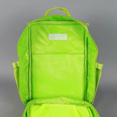 the back side of a lime green backpack with wheels on it and zippers at the bottom