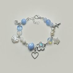 a bracelet with charms on it and a heart shaped charm attached to the bead