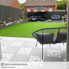 a small backyard with grass and furniture