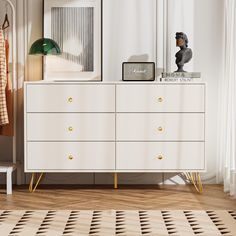 a white dresser sitting next to a window