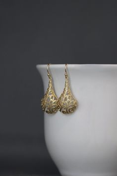 "Bold and detailed matte gold vermeil filigree charms simply dangle from gold vermeil balled earwires. These dramatic cut out charm earrings complete any outfit for daytime or evening. Gold charms: 19x32mm Total length of earrings: 1 3/4\" All gold is 18k gold vermeil. As the owner, maker, designer, and curator of this shop, I take great pride in providing you with jewelry that you will love to wear everyday, for special occasions, and for many years to come. Please read my Shop Policies which c 14k Gold Filigree Dangle Jewelry, Classic Gold Chandelier Earrings For Anniversary, Gold 14k Elegant Earrings, Elegant Matte Gold Wedding Jewelry, Teardrop-shaped Gold Plated Filigree Jewelry, Gold Plated Filigree Teardrop Jewelry, Elegant Gold Chandelier Earrings In Sterling Silver, Elegant Brass Jewelry With Intricate Design, Elegant Gold Plated Chandelier Earrings As A Gift