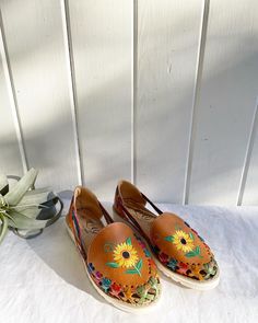 "Woven Mexican Sunflower Sandals/Loafers. Colorful. They feel like leather. Soles look new. Silver stain on the inside of the left upper tongue (please see pictures.) Size Women's: 10. The inside says 7, but the bottoms says 10. Check my measurements. Length of sole: 10 7/8\".  Orders over $35 ship for free. Please check out my Instagram for my newest finds: Hollyshopvintage  Everything priced over $35 has shipping already included in the total price. I'll gladly combine shipping on multiple ite Brown Round Toe Slip-ons For Summer, Summer Beach Slip-on Loafers, Closed Toe Slip-ons With Rubber Sole For Summer, Vintage Closed Toe Flats With Leather Footbed, Brown Round Toe Slip-ons For Spring, Brown Slip-on Flats For Spring, Vintage Brown Summer Flats, Bohemian Slip-on Sandals For Spring, Vintage Spring Flats With Rubber Sole