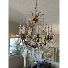 Transform your space with timeless elegance. This exquisite antique crystal chandelier, adorned with shimmering crystals and intricate gold hardware, evokes a bygone era of luxury and sophistication. Crafted with meticulous detail, each crystal reflects and refracts light, casting a mesmerizing glow that captivates any room. Whether adorning a grand foyer, dining room, or adding a touch of opulence to a bedroom, this chandelier is more than a lighting fixture—it's a statement piece that enhances the ambiance of any space. Perfect for those who appreciate the beauty of classic design and seek to bring a touch of history into their home. Don't miss the chance to own a piece of timeless beauty and craftsmanship. Antique Crystal Chandelier, Cardboard Chandelier, Foyer Dining Room, Stained Glass Chandelier, Vintage Crystal Chandelier, Grand Foyer, Crystal Chandeliers, Bygone Era, Gold Chandelier