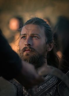 a man with long hair and beard wearing armor