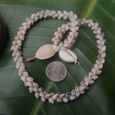 This necklace is an exquisite Kauai Momi Shell lei, that has taken many years to perfect. Not only will this necklace maintain it's integrity and luster, it will continue to gain in value exponentially. The Momi shells are only found on a few select beaches on Kauai and on the forbidden Island of Niihau. I collect my shells on the north shores of Kauai and sort each one by size, color, and quality. I then hand drill the holes in them in precisely the right place for this intricate and difficult Luxury White Double Strand Necklace, Spiritual Single Strand Round Jewelry, Spiritual Single Strand Jewelry, Unique Gold Single Strand Jewelry, Unique Single Strand Gold Jewelry, Elegant Hand-strung Lariat Necklace, Handmade Yellow Gold Lariat Jewelry, Luxury Handmade Double Strand Necklace, Spiritual Single Strand Long Necklace