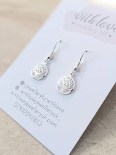 🌟 Stunning sterling stamped 925 silver ball and coil ear wires, holding a sterling silver tree of life charm.  🌟These earrings measure approx. 40mm from the top of the ear hook to the bottom of the charm.  The charm measures 12mm wide.  🌟 Lovely and light to wear for any occasion and if you don't like earrings with too much of a drop then these are perfect. ⭐ View the matching necklace here: https://www.etsy.com/uk/listing/635262597/sterling-silver-tree-of-life-necklace-16 🌟Your earrings will be sent to you on a card and and in an organza bag and also come with a little rubber earring back. 🌟 Due to hygiene reasons we are unable to accept earring returns. Earrings Necklace Set, Tree Of Life Earrings, Perfect View, Jewellery Earrings, Silver Tree, For Her Gifts, Ear Hook, Light Weight Earrings, Matching Necklaces