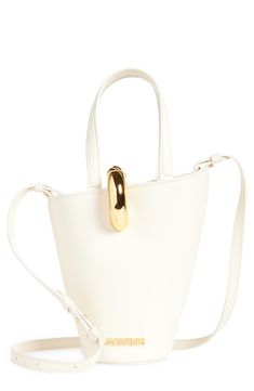 This asymmetric bucket bag is made in Italy from smooth leather and features a golden-ring magnetic clasp and matching logo hardware. Magnetic closure Top carry handles; removable, adjustable shoulder strap Interior zip pocket Structured silhouette with flat base for stability Cotton lining Leather Made in Italy Designer Handbags Modern Bucket Shoulder Bag With Brass Hardware, Elegant Bucket Bag With Brass Hardware, Elegant Top Handle Bucket Bag With Brass Hardware, Modern Bucket Bag With Brass Hardware For Daily Use, Chic Bucket Bag With Metal Hardware And Double Handle, Chic Bucket Bag With Brass Hardware Tote, Chic Tote Bucket Bag With Brass Hardware, Chic Bucket Bag Tote With Brass Hardware, Formal Bucket Bag With Brass Hardware