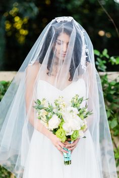 a woman in a wedding dress holding a bouquet