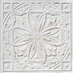 a white ceiling tile with an intricate design on the center and bottom part of it