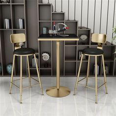 two black and gold bar stools in front of a table with bookshelves