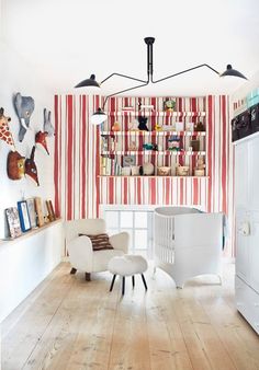 a baby's room with red and white striped walls