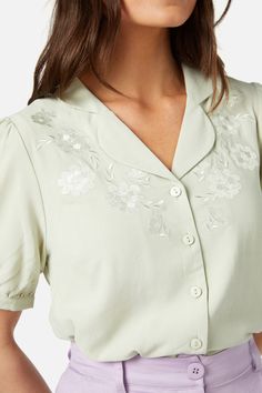 Floral embroidered short sleeve blouse. The perfect office or casual style - open styled collar - short puff sleeve with cuff - button through front - made of a viscose tencle blend - available in lilac & mint Product Code: PGFY126 Daywear Blouse With Camp Collar, Short Sleeve Embroidered Shirt For Work, Fitted Embroidered Top With Collared Neckline, Summer Embroidered Shirt With Collared Neckline, Classic Collared Rayon Tops, Embroidered Summer Blouse With Collared Neckline, Classic Short Sleeve Rayon Tops, Collared Floral Embroidery Top For Work, Spring Short Sleeve Shirt With Cuffed Sleeves