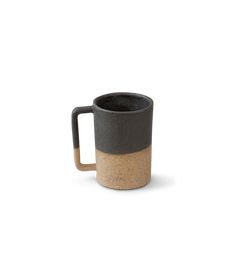 a black and tan coffee mug on a white background