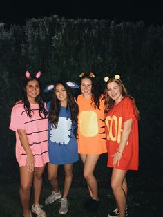 four girls in costumes posing for the camera