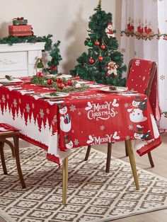 a christmas themed table cloth with snowmen and trees on it