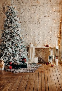 a decorated christmas tree in front of a brick wall with lights and presents on the floor