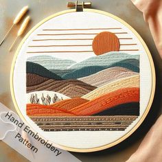 a cross stitch pattern with an orange sun in the background