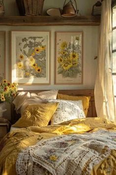 a bedroom with sunflowers on the wall and pictures above the bedspread