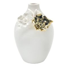 a white and gold vase with flowers on the top is shown against a white background