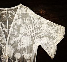 "This overlayering piece is made with soft embroidered sheer lace, features mid sleeve with scalloped sleeve edge and hem. Makes for a super sweet cover up for any outfit! ONE SIZE FITS MOST - SMALL, MEDIUM, LARGE Length: 37\" Bust: 23\" (open front, one size fits all) Armhole: 11\" Now when you order two items or more, your shipping is on us! Enter FREESHIP at checkout! ( US shipping only) And/Or Share your photo with me in the item you purchased, you will receive a $15 coupon toward your next Bohemian Fitted Lace For Spring, Fitted Bohemian Lace For Spring, Bohemian Lace Patchwork For Spring, Bohemian Summer Lace With Lace Patchwork, Bohemian Lace With Lace Patchwork For Summer, Bohemian Open Front Kimono With Floral Embroidery, Bohemian Floral Embroidered Open Front Kimono, White Kimono With Lace Trim, Fitted Summer Kimono With Embroidery