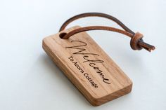 a wooden keychain with the name and date engraved on it