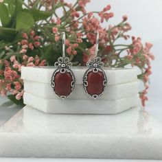 Natural Red Jasper & Sterling Silver Handmade Artisan Crafted Filigree Oval Drop Earrings Matching ring is available https://www.etsy.com/listing/1255431024/natural-red-jasper-silver-ring-sterling?ref=listings_manager_grid Material: 925 Solid Sterling Silver, 925 Stamped Natural Red Jasper Gemstones Dimensions:14 mm x 10 mm, Oval, Cabochon Earrings Length: 1.40 inches Width: 0.50 inches Closure: Ear wire with safety catch Finishing: Oxidized & polished Comes with a free gift pouch and box Free D Artisan Red Jewelry For Anniversary, Artisan Red Sterling Silver Jewelry, Ornate Red Sterling Silver Earrings, Elegant Silver Carnelian Earrings, Silver Carnelian Jewelry With Ear Wire, Handmade Red Sterling Silver Earrings, Nickel-free Red Carnelian Earrings, Artisan Nickel-free Red Earrings, Artisan Red Nickel-free Earrings