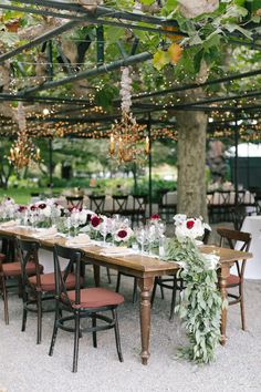 an outdoor dining area with tables and chairs set up for a formal dinner or party