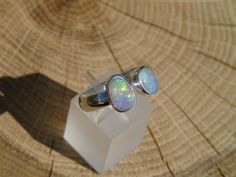 Open ended silver ring with 2 Coober Pedy opals. Both opals have beautiful bright yellow, green, blue and purples. One is approximately 0.8ct and 8x6mm, the other 1ct and 9x6mm. Size S UK/Aus, 9.25US, plain band, 4.5mm width. As ring is open ended there is some variation on size available. Nickel-free Opal Rings As Gifts, Nickel-free Opal Ring As Gift, Nickel-free Adjustable Opal Rings, Adjustable Opal Rings For Gifts, Silver Opal Ring Gift, Opal Crystal Open Ring As Gift, Adjustable Opal Rings Gift, Adjustable Opal Ring For Gift, Opal Open Ring Crystal Ring For Gift