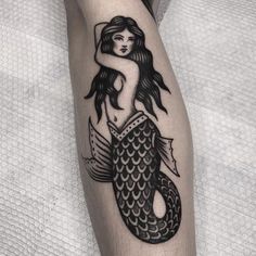 a woman with a fish tattoo on her leg