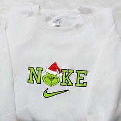 Introducing the Grinch Christmas x Nike Movie Embroidered Sweatshirt, a must-have for all Nike enthusiasts and Christmas lovers! This unique sweatshirt features intricate embroidery of the iconic Grinch character alongside the classic Nike logo, creating a one-of-a-kind fusion. Made from premium quality materials, it ensures ultimate comfort and durability. Perfect as a gift for your loved ones, this sweatshirt combines the joy of Christmas with the style and authenticity of Nike. Spread the hol Nike Inspiration, Nike Inspired, Unique Sweatshirt, Cartoon Shirts, Cartoon Sweatshirts, Family Christmas Gifts, Hoodie Material, Embroidered Clothes, Embroidered Sweatshirt